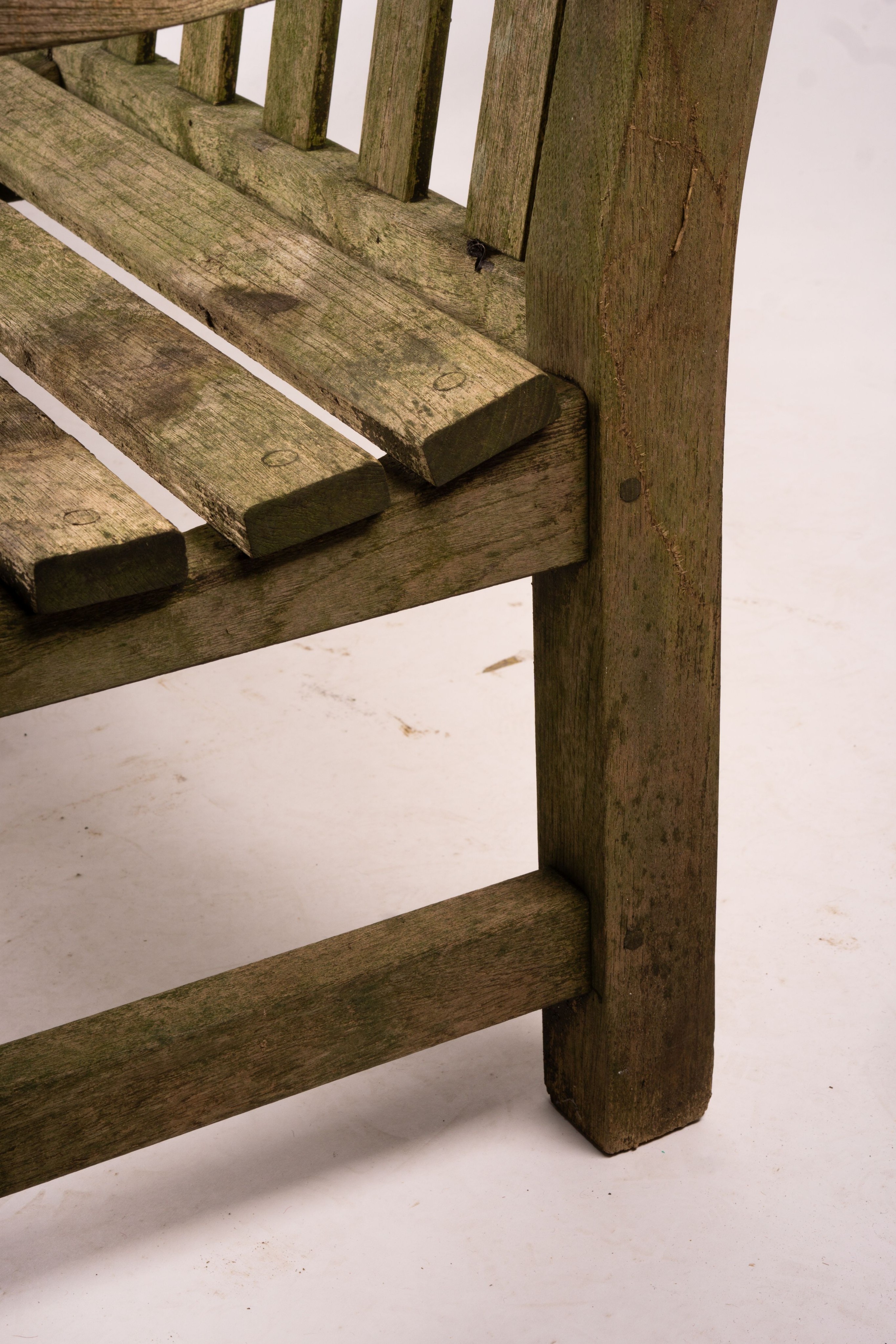 A weathered teak garden bench, length 192cm, width 60cm, height 85cm